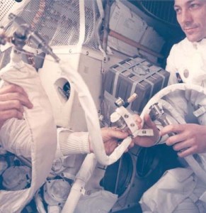 Jack Swigert helps jury-rig the "mailbox," the lithium-hydroxide cannisters needed to purge carbon dioxide from the air inside the lunar module on their trip home. Photo: NASA
