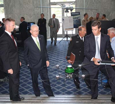 Representative "Buck" McKeon, second from left, watches a demonstraton of a rotary UAV.