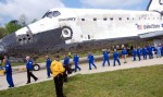 Discovery rolled into view with a parade of its former astronaut commanders.